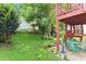 Lush backyard featuring a patio area with outdoor seating beneath a wooden deck at 4303 Anderson Ridge Dr, Austell, GA 30106