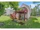 Exterior of backyard with a patio, green yard, and trees for cool shade at 4303 Anderson Ridge Dr, Austell, GA 30106