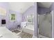 A spa-like bathroom features a tub, shower, vanity, and bright natural light from the window at 4303 Anderson Ridge Dr, Austell, GA 30106