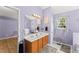 Bright, light purple bathroom with double vanity, carpeted floors, and decorative mirrors at 4303 Anderson Ridge Dr, Austell, GA 30106