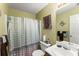 Bathroom featuring a shower-tub combination, vanity with sink, and soft green color palette at 4303 Anderson Ridge Dr, Austell, GA 30106