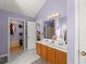 Bathroom with double sink, carpeted floors, marble floors in front of vanity, and an open closet at 4303 Anderson Ridge Dr, Austell, GA 30106