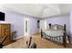 Bedroom with light purple walls, wood floor, and a comfortable bed and vaulted ceiling at 4303 Anderson Ridge Dr, Austell, GA 30106