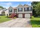 Charming two-story home with a well-maintained lawn and an inviting entrance and two-car garage at 4303 Anderson Ridge Dr, Austell, GA 30106
