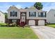 Charming two-story home with a well-maintained lawn and an inviting entrance and two-car garage at 4303 Anderson Ridge Dr, Austell, GA 30106