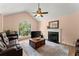 Cozy living room featuring a fireplace, large window, plush seating, and hardwood floors at 4303 Anderson Ridge Dr, Austell, GA 30106