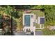Aerial view of stunning backyard featuring a pool, spa, cabana, lounge area, and mature landscaping at 4495 Westgate Dr, Cumming, GA 30040