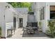 Outdoor patio with dining set, string lights, and charming architectural details at 4495 Westgate Dr, Cumming, GA 30040