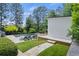 Landscaped backyard with a luxurious pool, hot tub, and stylish pool house, perfect for outdoor living at 4495 Westgate Dr, Cumming, GA 30040