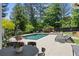 Outdoor dining by the pool, featuring hanging chairs for relaxing backyard living at 4495 Westgate Dr, Cumming, GA 30040