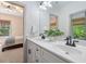Bright bathroom features a dual vanity with quartz countertop and black hardware at 4495 Westgate Dr, Cumming, GA 30040