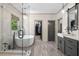 Bright bathroom featuring a soaking tub, glass shower, and gray vanity with modern fixtures at 4495 Westgate Dr, Cumming, GA 30040