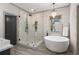 Modern bathroom with a freestanding tub, frameless shower, and elegant fixtures at 4495 Westgate Dr, Cumming, GA 30040