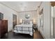 Bedroom with hardwood floors, crystal chandelier, and natural light at 4495 Westgate Dr, Cumming, GA 30040