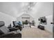 Bonus room with vaulted ceiling, carpet, a window, media center and two leather chairs at 4495 Westgate Dr, Cumming, GA 30040