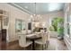 Traditional dining room with wainscoting, hardwood floors, and an elegant chandelier at 4495 Westgate Dr, Cumming, GA 30040