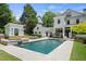 Spacious backyard with a pool, spa, and pool house complementing a beautifully designed home at 4495 Westgate Dr, Cumming, GA 30040