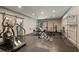 Spacious home gym with modern exercise equipment, a large mirror, and storage for a comprehensive fitness space at 4495 Westgate Dr, Cumming, GA 30040