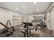 Well-equipped home gym featuring weight training equipment, mirrors, and storage for a complete workout experience at 4495 Westgate Dr, Cumming, GA 30040