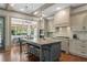 Bright eat-in kitchen features an island with bar stool seating, stainless steel appliances, and a view to the breakfast nook at 4495 Westgate Dr, Cumming, GA 30040