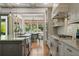 View of the kitchen with white subway tile backsplash and stainless appliances with a dining area at 4495 Westgate Dr, Cumming, GA 30040