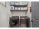 Well-lit laundry room with modern washer and dryer and ample shelving for storage at 4495 Westgate Dr, Cumming, GA 30040