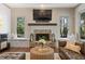 Cozy living room featuring a stone fireplace and window seats at 4495 Westgate Dr, Cumming, GA 30040