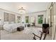 Bright main bedroom with a crystal chandelier, white linens, and a decorative area rug at 4495 Westgate Dr, Cumming, GA 30040