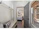 Hallway with coat hooks, a bench, wood floors and a view into the bedroom at 4495 Westgate Dr, Cumming, GA 30040