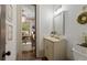 Chic powder room with a decorative mirror and views of the adjacent office at 4495 Westgate Dr, Cumming, GA 30040