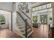 Staircase leading to the upper level, with hardwood floors and views of the living space at 4495 Westgate Dr, Cumming, GA 30040