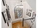 Staircase with wood treads, white risers, modern chandelier and gallery wall at 4495 Westgate Dr, Cumming, GA 30040