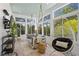 Bright sunroom featuring lots of windows, hanging egg chair and a daybed at 4495 Westgate Dr, Cumming, GA 30040