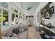 Bright sunroom with a hanging swing chair, modern furniture, and a view of the pool at 4495 Westgate Dr, Cumming, GA 30040