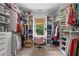 Spacious walk-in closet featuring custom shelving, hanging rods, and a vanity area at 4495 Westgate Dr, Cumming, GA 30040