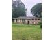 Charming brick ranch home with a well-manicured lawn and mature trees providing ample shade at 4961 Ivey Road, Acworth, GA 30101