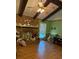A charming living room features a brick fireplace, hardwood floors, and bright green walls at 4961 Ivey Road, Acworth, GA 30101