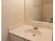 Half-bathroom features a white vanity with sink and a decorative mirror at 5587 Trace Views Dr, Norcross, GA 30071
