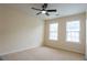 Carpeted bedroom features natural light and a ceiling fan at 5587 Trace Views Dr, Norcross, GA 30071