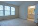 Neutral bedroom with large windows and access to an ensuite bathroom at 5587 Trace Views Dr, Norcross, GA 30071