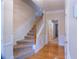 Inviting hallway features hardwood floors, staircase, and detailed trim work, leading to other rooms at 5587 Trace Views Dr, Norcross, GA 30071