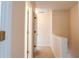 Well lit hallway with neutral paint and carpet, leading to other rooms at 5587 Trace Views Dr, Norcross, GA 30071