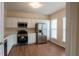 Bright kitchen with white cabinets, stainless steel appliances, and hardwood floors at 5587 Trace Views Dr, Norcross, GA 30071