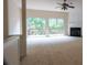 A spacious living room with carpet, a fireplace, and sliding glass doors to a balcony at 5587 Trace Views Dr, Norcross, GA 30071