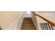 Carpeted stairs with white trim and a wood railing, leading to the upper level at 5587 Trace Views Dr, Norcross, GA 30071