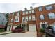 The brick townhouse features a one-car garage, trimmed windows, and well-maintained landscaping at 5587 Trace Views Dr, Norcross, GA 30071