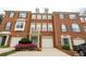 A brick townhouse featuring a one-car garage, trimmed windows, and well-maintained landscaping at 5587 Trace Views Dr, Norcross, GA 30071