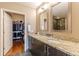 Dual sink vanity with granite countertops and a walk-in closet at 1080 Ne Peachtree Ne St # 2802, Atlanta, GA 30309