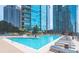 Large outdoor pool surrounded by lounge seating and city views at 1080 Ne Peachtree Ne St # 2802, Atlanta, GA 30309