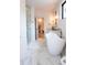 Bathroom featuring a modern soaking tub, glass shower, and elegant fixtures at 3681 Hamilton Mill Rd, Buford, GA 30519